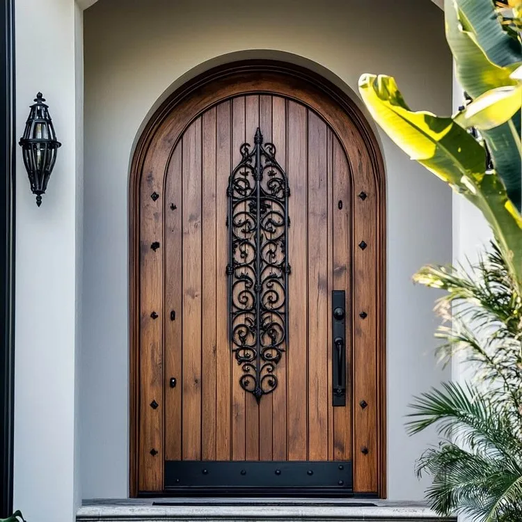 Arched Main Door Design with Wrought Iron Detailing